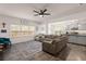 Open-concept living room with a large sofa, ceiling fan, and view into the kitchen at 150 Rockingham Way, Moncks Corner, SC 29461