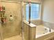 The bathroom showcases a glass-enclosed shower adjacent to a soaking tub at 1915 Sweetfern Rd, Hanahan, SC 29410