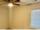 A bedroom features a ceiling fan, neutral walls, and a window with blinds at 1915 Sweetfern Rd, Hanahan, SC 29410