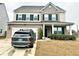 Charming two-story home with a brick facade, well-manicured lawn, and a private driveway at 1915 Sweetfern Rd, Hanahan, SC 29410
