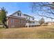 Backyard with a spacious deck and a brick foundation with a well-manicured lawn at 193 Shadowmoss Pkwy, Charleston, SC 29414