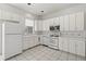 All-white kitchen with ample cabinet space and modern appliances at 193 Shadowmoss Pkwy, Charleston, SC 29414