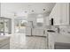 Bright white kitchen with tile floors, white appliances, and plenty of natural light at 193 Shadowmoss Pkwy, Charleston, SC 29414