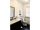 Cozy bathroom features black and white tile, a modern sink and toilet, and decorative wicker mirror at 2008 Cosgrove Ave, North Charleston, SC 29405