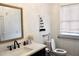 Bright bathroom featuring white walls, a decorative mirror, modern sink, and accessible toilet at 2008 Cosgrove Ave, North Charleston, SC 29405