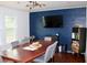 Spacious dining room with a large table, modern chandelier, accent wall, and built in bookcase at 2008 Cosgrove Ave, North Charleston, SC 29405