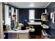 Well-lit home office space with dark blue walls and hardwood flooring at 2008 Cosgrove Ave, North Charleston, SC 29405