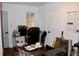A cluttered office space with a desk, chair, and various items, showcasing a functional area at 2008 Cosgrove Ave, North Charleston, SC 29405