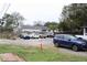 Gravel parking lot featuring several cars parked in front of a home at 2008 Cosgrove Ave, North Charleston, SC 29405
