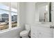 Half bathroom featuring a white toilet and a vanity with a rectangular mirror at 212 Denham St, Summerville, SC 29486