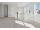 Second-story hallway with carpet and natural light streaming through windows at 212 Denham St, Summerville, SC 29486