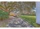 Backyard featuring a boat parked next to a garage, shaded by a large tree and partial view of the home at 2181 Edisto Ave, Charleston, SC 29412