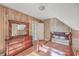 Cozy bedroom featuring wood paneled walls, a wooden bed frame, and a dresser with a large mirror at 2181 Edisto Ave, Charleston, SC 29412