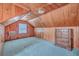 Angle shot of a bedroom with wood paneled walls, plush carpet, and a vintage window air conditioner at 2181 Edisto Ave, Charleston, SC 29412