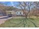 Exterior view of home showcasing a carport and a spacious, shady front yard at 2181 Edisto Ave, Charleston, SC 29412