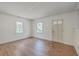 Bright living room featuring hardwood floors, two windows, and a classic interior door at 2181 Edisto Ave, Charleston, SC 29412