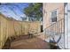 Backyard patio featuring brick pavers, wrought iron furniture, a wall with climbing plants, and stairs to the house at 249 Ashley Ave, Charleston, SC 29403