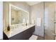 Bathroom showcasing double sinks, a large mirror with lighting, and a walk-in shower with glass door at 249 Ashley Ave, Charleston, SC 29403