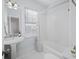Bright bathroom features a single sink, large mirror, subway tile backsplash, and bathtub at 249 Ashley Ave, Charleston, SC 29403