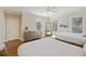 Bright bedroom with two beds, hardwood floors, a ceiling fan, and natural light from the windows at 249 Ashley Ave, Charleston, SC 29403