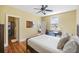 Bright bedroom features hardwood floors, ceiling fan, and ensuite bathroom with tiled shower at 249 Ashley Ave, Charleston, SC 29403