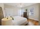 This cozy bedroom is decorated with hardwood floors, a ceiling fan, and multiple windows at 249 Ashley Ave, Charleston, SC 29403