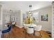 Bright dining area with a modern table, chairs, and a unique yellow cabinet at 249 Ashley Ave, Charleston, SC 29403