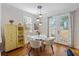 Bright dining area with doors to exterior and hardwood flooring at 249 Ashley Ave, Charleston, SC 29403