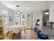 Bright dining area with a modern table and chairs, hardwood floors, and a breakfast bar at 249 Ashley Ave, Charleston, SC 29403
