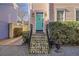 Close-up of the home's front door, featuring a turquoise door, brick steps, and classic lighting at 249 Ashley Ave, Charleston, SC 29403