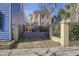 Charming exterior view of a two-story home with a gated entrance and well-maintained landscaping at 249 Ashley Ave, Charleston, SC 29403