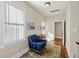 Hallway seating area with natural light and blue chair is conveniently located near the bedrooms at 249 Ashley Ave, Charleston, SC 29403