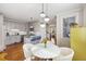 Well-lit kitchen area flows into dining space with hardwood floors and stainless steel appliances at 249 Ashley Ave, Charleston, SC 29403