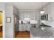 Bright kitchen featuring stainless steel appliances and gray cabinetry with granite counters at 249 Ashley Ave, Charleston, SC 29403
