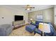 Cozy living room featuring a large, comfortable sectional sofa, a ceiling fan, and wood floors at 249 Ashley Ave, Charleston, SC 29403