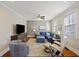 Bright living room with stylish furnishings, neutral walls, and a decorative ceiling fan at 249 Ashley Ave, Charleston, SC 29403