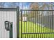 A black metal backyard gate with a keycode entry, white fence, and privacy fence at 250 Hillcrest Dr, Moncks Corner, SC 29461