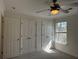 Bright bedroom with neutral carpet, ceiling fan, and a window at 25D Brockman Dr # 25-A, Charleston, SC 29412