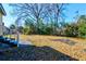 Backyard featuring a large grassy space and staircase with wooden railing at 2694 Olympia Ave, North Charleston, SC 29405