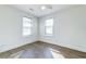 Bedroom with wood floor, ceiling fan, and two large windows at 2694 Olympia Ave, North Charleston, SC 29405