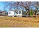 Charming single-story home with blue door, grey shutters, and chain link fence at 2694 Olympia Ave, North Charleston, SC 29405
