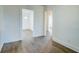Hallway featuring neutral walls and stylish wood-look flooring with entry door at end at 2694 Olympia Ave, North Charleston, SC 29405
