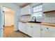 Modern kitchen with white cabinets, butcher block countertop, and subway tile backsplash at 2694 Olympia Ave, North Charleston, SC 29405
