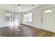 Bright, airy living room with wood floors, ceiling fan, and many windows at 2694 Olympia Ave, North Charleston, SC 29405