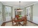 Dining room with a wood table, china cabinet, and window shutters at 297 Hundred Oaks Pkwy, Summerville, SC 29483