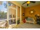 Comfortable screened porch with wicker furniture, ceiling fan, area rug, and bright yellow paneling at 297 Hundred Oaks Pkwy, Summerville, SC 29483