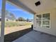 A covered back porch with a concrete floor overlooks a grassy area and showcases the home's exterior at 3004 Harvey Ave, North Charleston, SC 29405