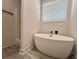 Bathroom featuring a soaking tub and separate shower with white walls and tiled floor at 3004 Harvey Ave, North Charleston, SC 29405