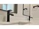 Close up of the bathroom vanity with white counters and stylish matte black faucet fixtures at 3004 Harvey Ave, North Charleston, SC 29405