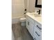 Bathroom featuring white vanity with black hardware, toilet, and shower at 3004 Harvey Ave, North Charleston, SC 29405
